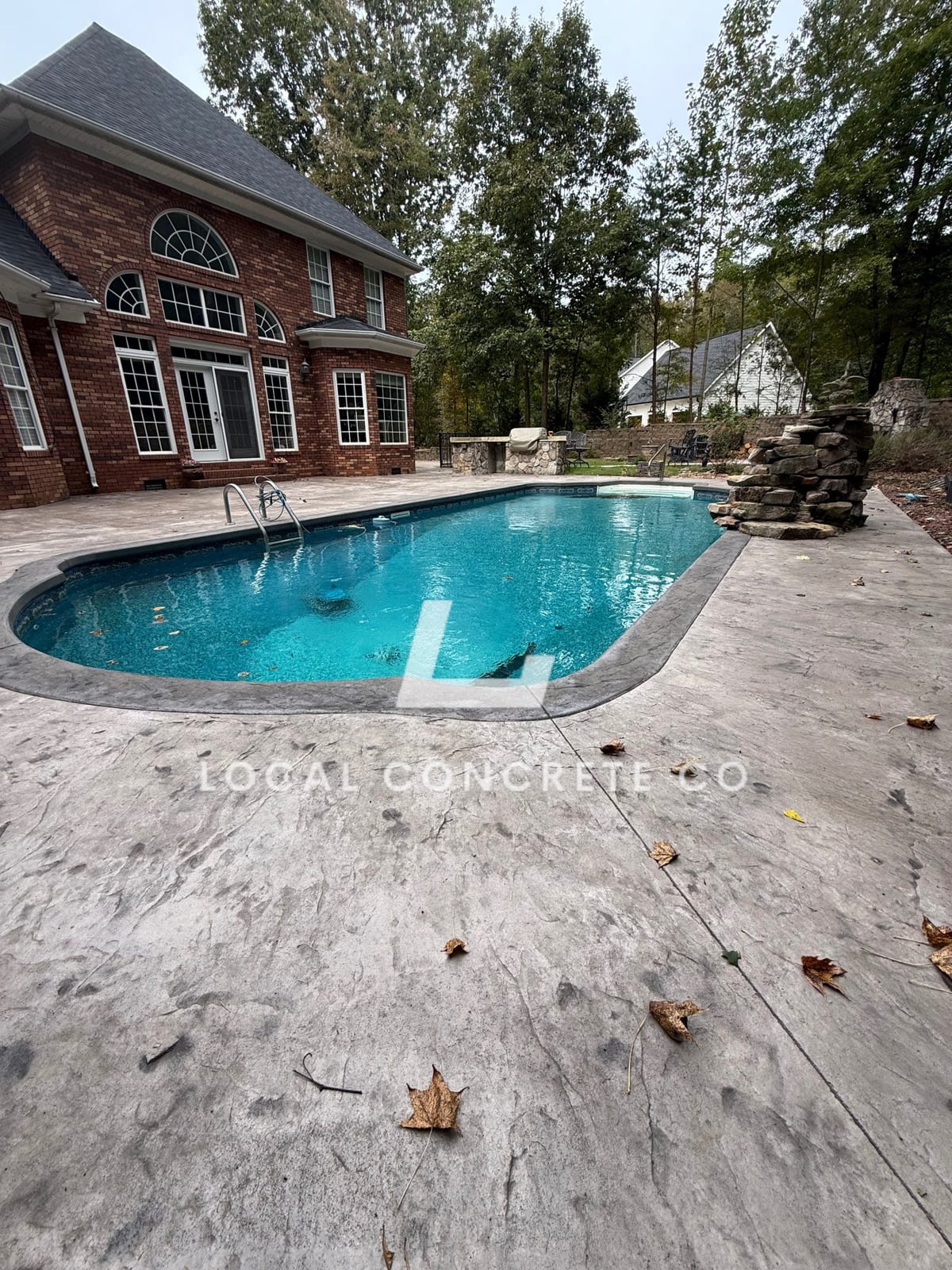 After photo of a finished concrete installation in Charlotte, NC (Mecklenburg County) by Local Driveway Co — broom-finish surface, sawn control joints, full-depth replacement with 4000 PSI commercial mix and double-mat structural rebar, pay-on-completion.