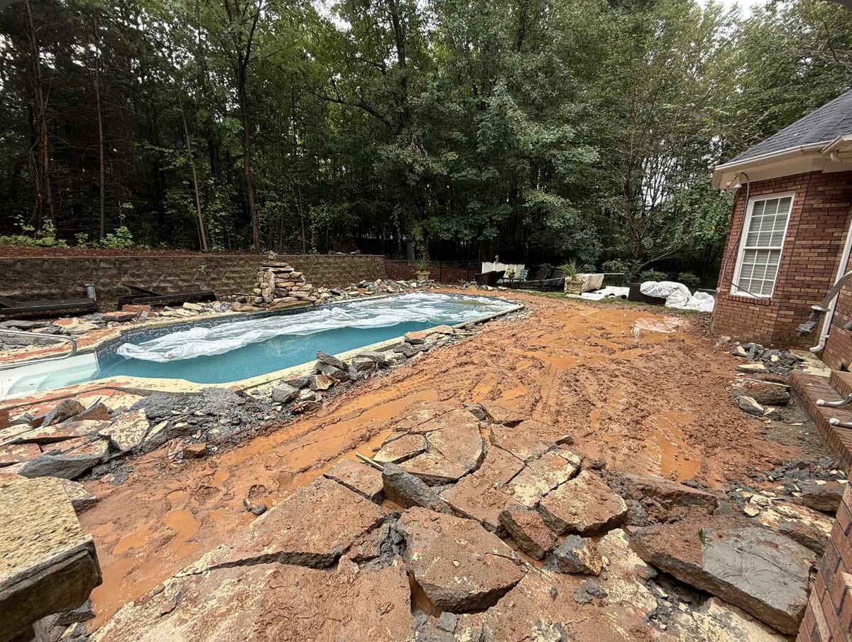 Before photo of a concrete restoration job in Charlotte, NC (Mecklenburg County) by Local Driveway Co — failed slab, surface spalling, and structural cracking documented prior to full demolition and replacement with 4000 PSI mix and #4 rebar.
