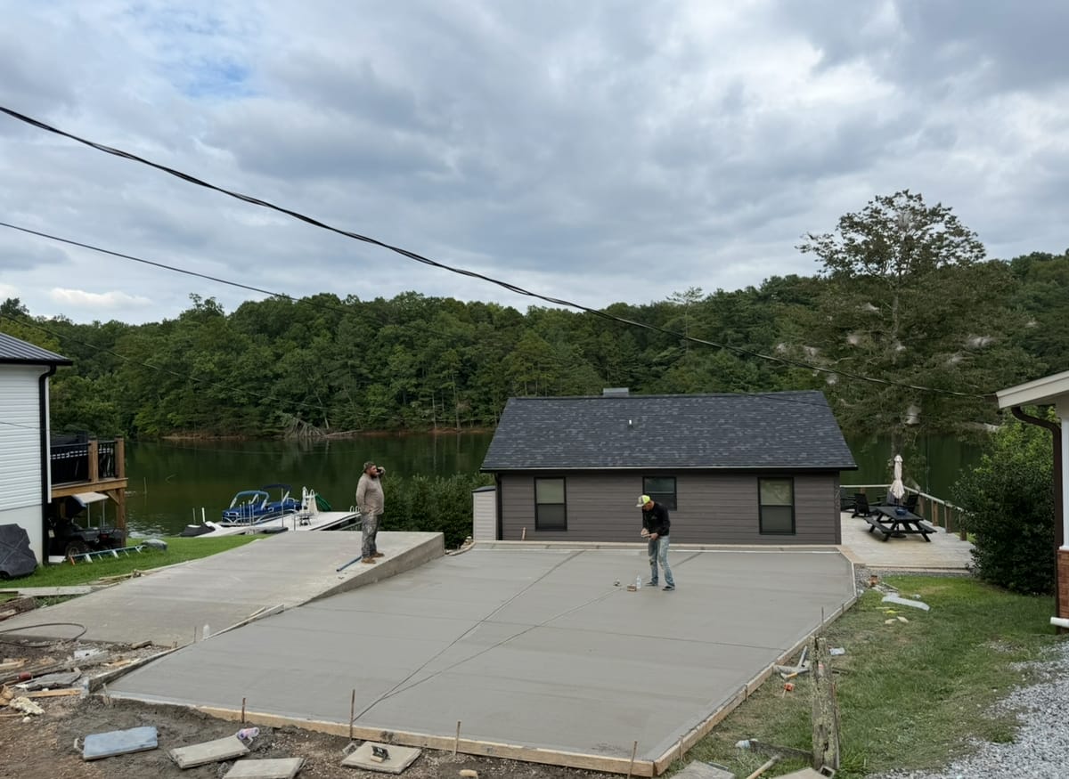 After photo of a finished concrete installation in Concord, NC (Cabarrus County) by Local Driveway Co — broom-finish surface, sawn control joints, full-depth replacement with 4000 PSI commercial mix and double-mat structural rebar, pay-on-completion.