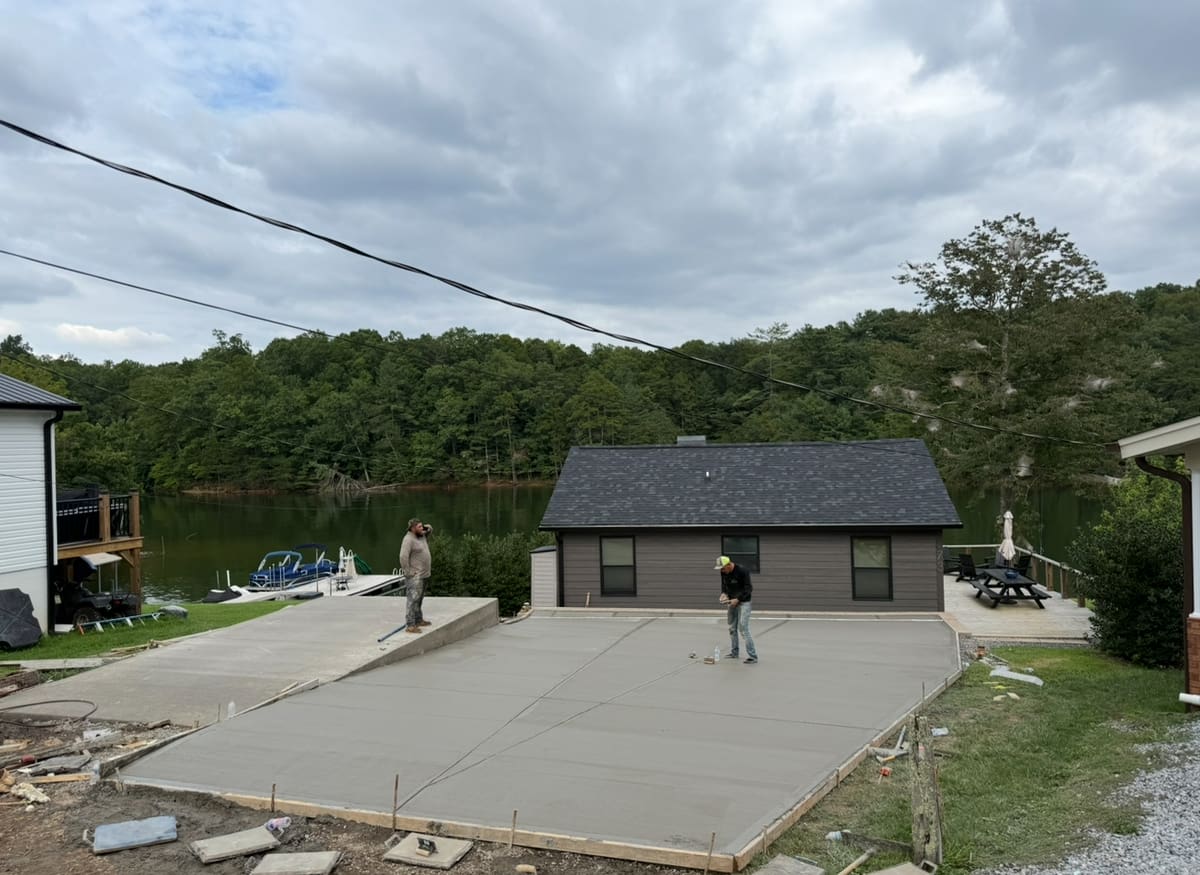 After photo of a finished concrete installation in Statesville, NC (Iredell County) by Local Driveway Co — broom-finish surface, sawn control joints, full-depth replacement with 4000 PSI commercial mix and double-mat structural rebar, pay-on-completion.